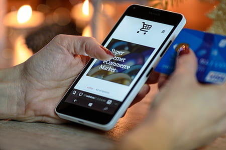 person holding white Windows smartphone on left hand thumbnail