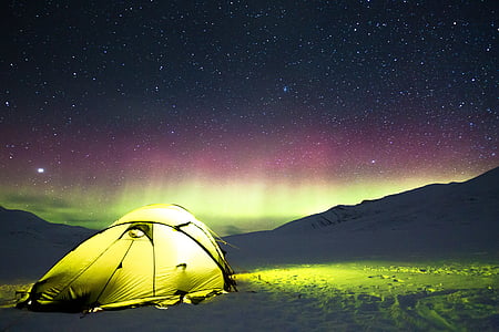 yellow tent across silhouette of mountain thumbnail