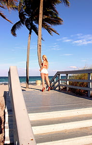 woman standing near coconut tree thumbnail