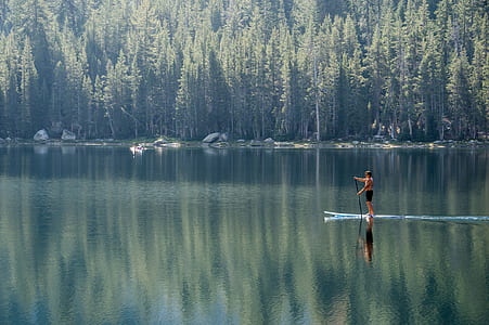 person paddle boarding during daytime thumbnail