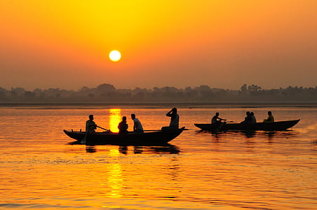 silhouette photo of people riding boat during golden hour thumbnail