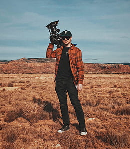 man holding camcorder and standing on the ground thumbnail