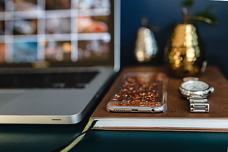 Home office desk with Macbook, iPhone, calendar, watch & organizer thumbnail