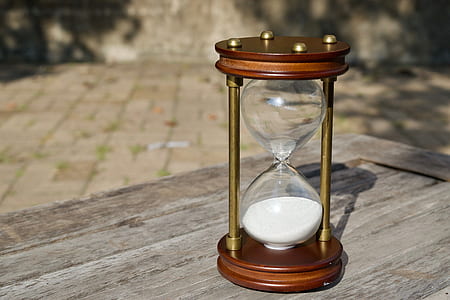 brown hourglass on brown wooden surface thumbnail