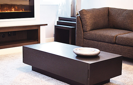 round grey metal plate on a brown wooden coffee table thumbnail