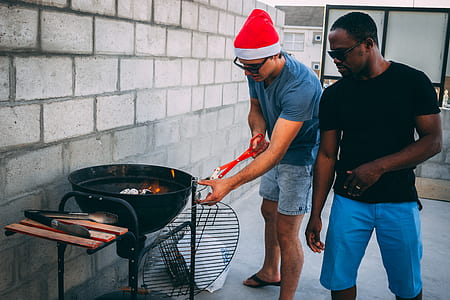 two men standing infront of grill thumbnail