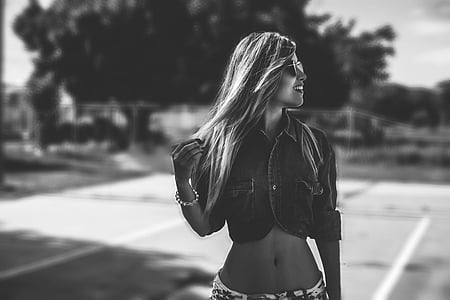 grayscale photo of woman in crop top and bottoms with sunglasses thumbnail