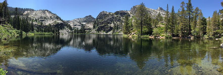 landscape photography of body of water near mountain thumbnail