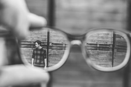 shallow focus photography of man standing in front of wall thumbnail