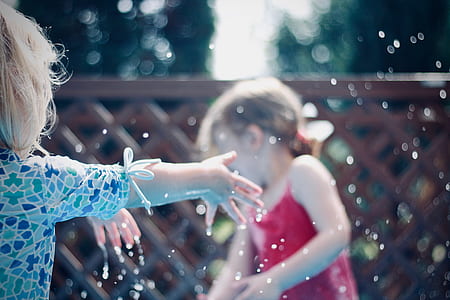 time lapse photo of two girls playing with water thumbnail