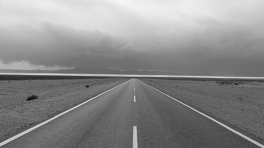 greyscale photo of road and sky with clouds thumbnail