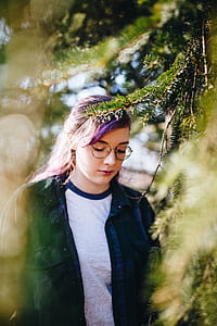 selective focus photography of woman with hippie eyeglasses under a tree thumbnail