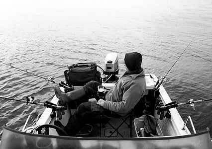 grayscale photo of man on boat thumbnail