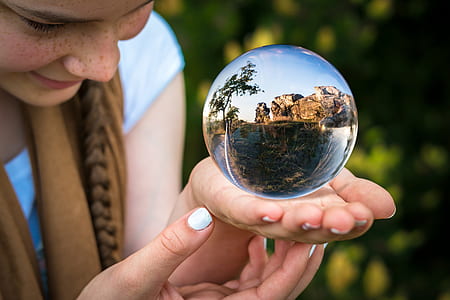 women holding clear glass globe thumbnail