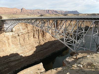 photo of gray metal bridge on brown rock formation at daytime thumbnail