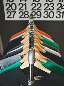 selective focus photography of hanged scoop neck shirts thumbnail