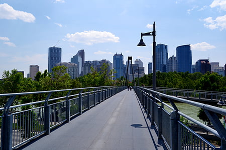 people walking on metal bridge during daytime thumbnail