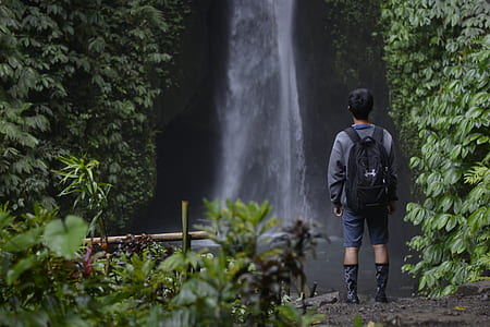 man staring at waterfalls thumbnail