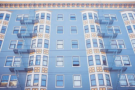 low angle photography of blue and white high-rise building thumbnail