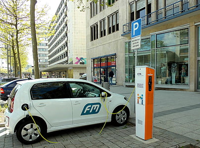 white 5-door hatchback park near building at daytime thumbnail
