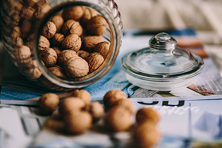 Jar full of walnuts with a fresh healthy shake and musli in a bowl thumbnail