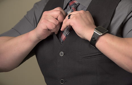 close-up photo of person holding necktie thumbnail