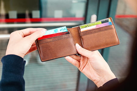 Girls hands holding a wallet with a credit card on the street thumbnail