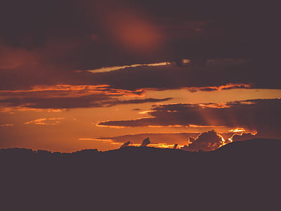 silhouette of mountain under cloudy sky thumbnail