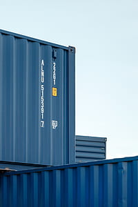 gray intermodal containers stacking together under clear blue sky thumbnail