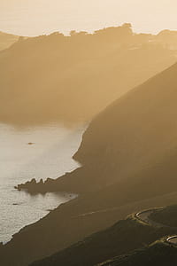 body of water beside mountain thumbnail