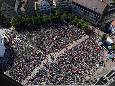 crowd of people between buildings during daytime thumbnail