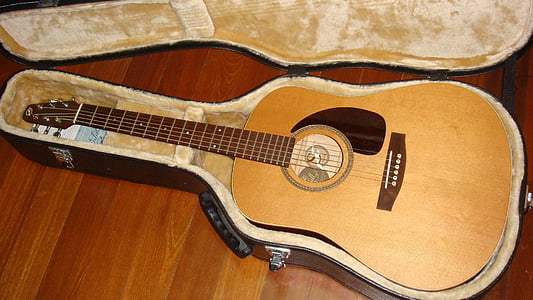 brown dreadnought acoustic guitar in black guitar case thumbnail