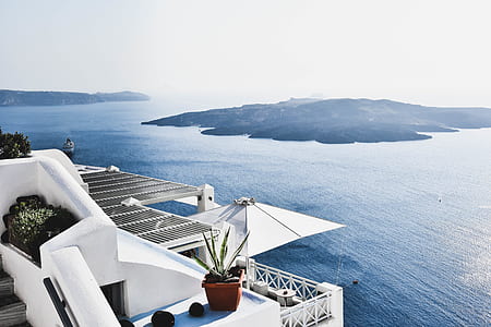 building beside blue sea water thumbnail