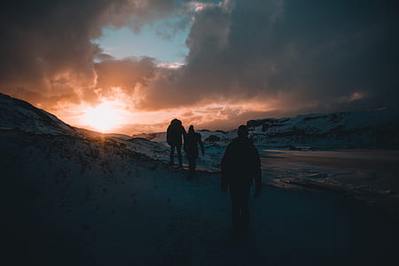 silhouette photography of three person climbing mountain thumbnail