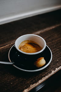 black teacup filled with brown liquid thumbnail