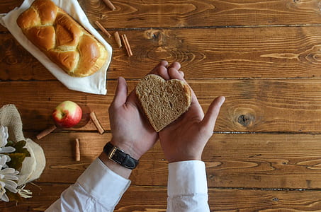 Person Holding Heart Shaped Bread thumbnail