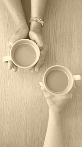 photographed of two person holding mugs thumbnail