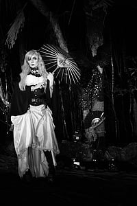 grayscale photography of woman holding parasol thumbnail