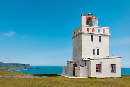 white concrete building on the cliff under blue sky thumbnail