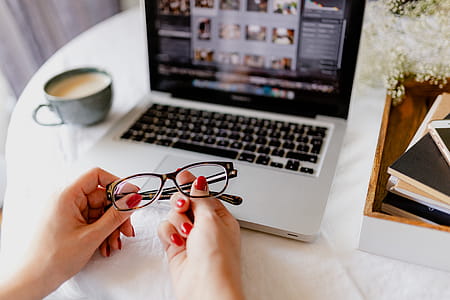 A woman works at a desk with a laptop and a cup of coffee thumbnail