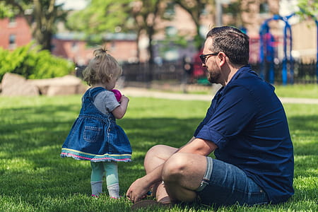 man sitting on the grass in front of girl thumbnail