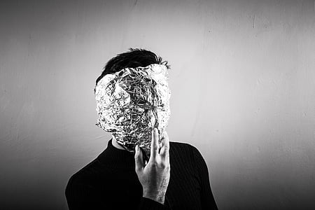 grayscale photo of man with foil wrap on his face thumbnail