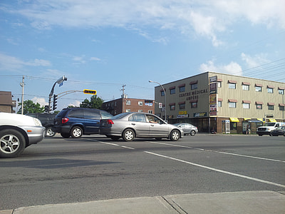 assorted vehicles travelling on road during daytime thumbnail