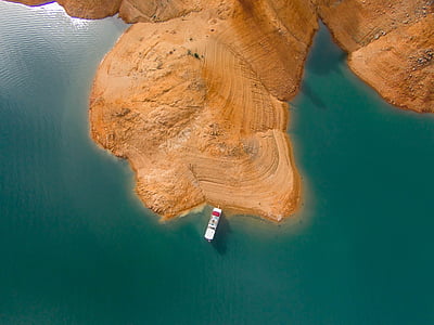 white ship next to brown land thumbnail