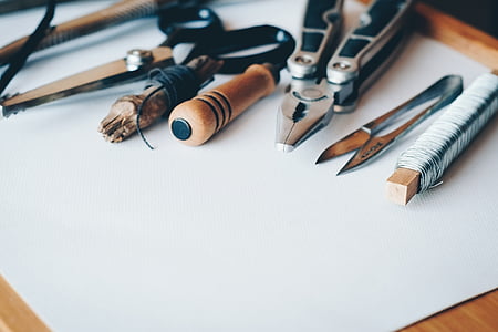 selective focus photography of pliers and scissors on white printer paper thumbnail