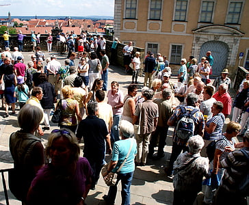 people standing and walking near concrete building during daytime thumbnail