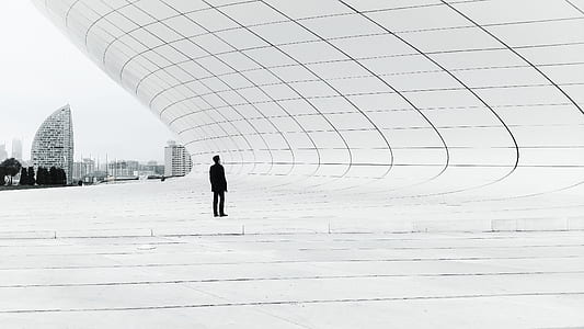 man standing in front of building thumbnail
