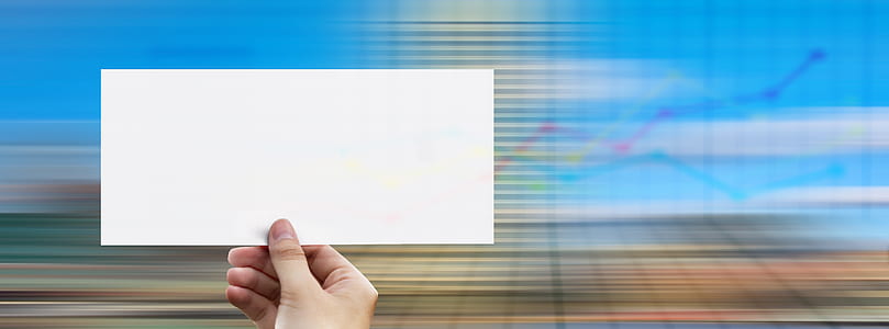 person holding white paper thumbnail
