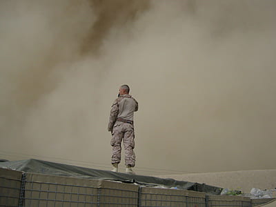 man wearing camouflage overall suit standing thumbnail