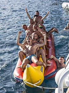 group of men riding banana boat thumbnail